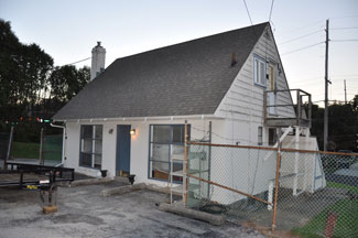 The small house that became the team office in front of the Penske Racing shop in Newtown Square, Penn.